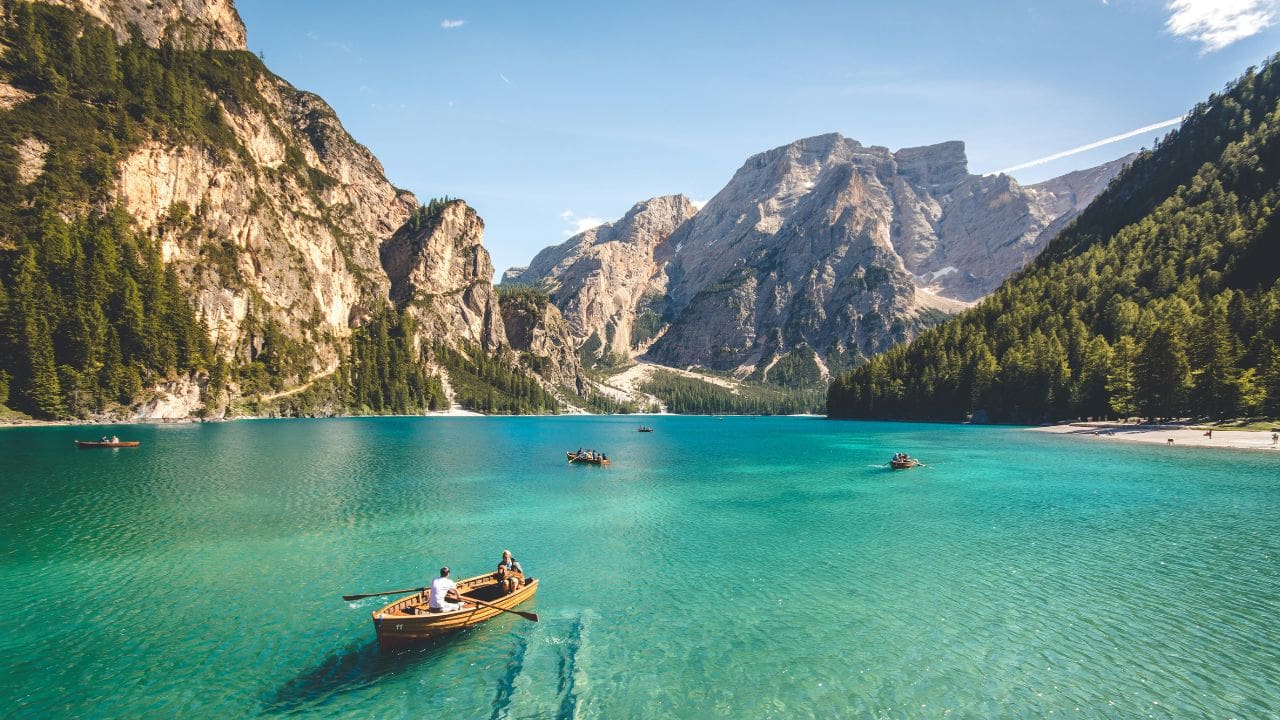 photo of canoe and mountains in Pragser Wildsee, Italy