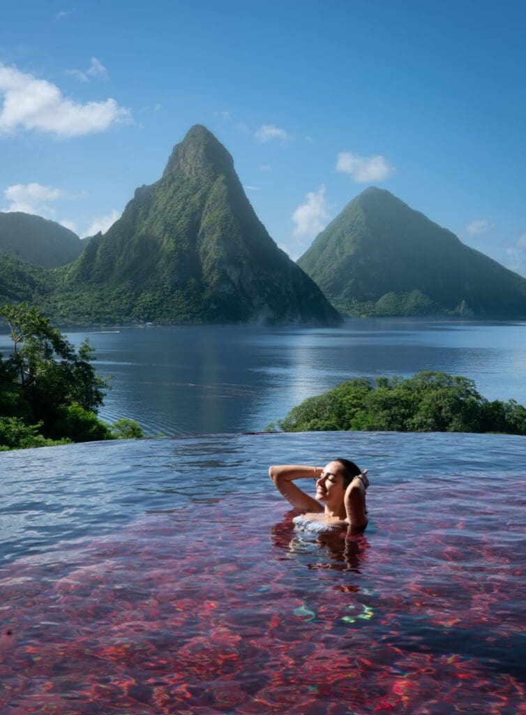 Photo of woman relaxing in pool at Jade Mountain Resort with the Pitons behind her