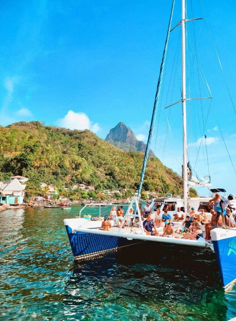 photo of catamaran sunset cruise in St. Lucia with the Piton behind it.