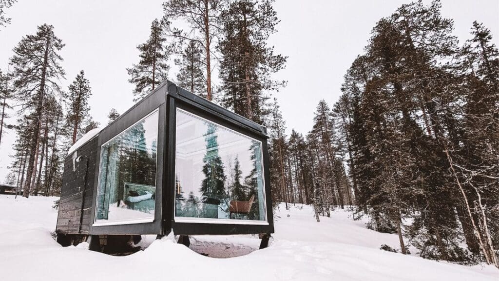photo of glass igloo in Finland surrounded by snow
