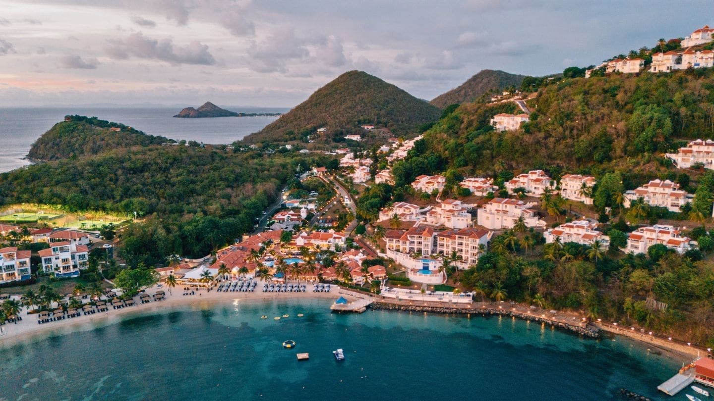 drone photo of Windjammer Landing in St. Lucia with hills and Pigeon Island in the background