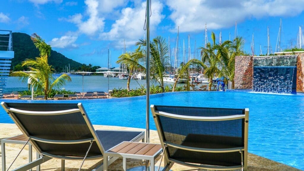 photo of loungers looking out at pool and Rodney Bay from The Harbor Club in St. Lucia