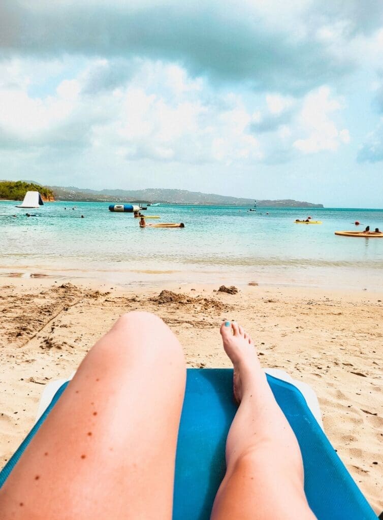 photo of legs with beach in the background