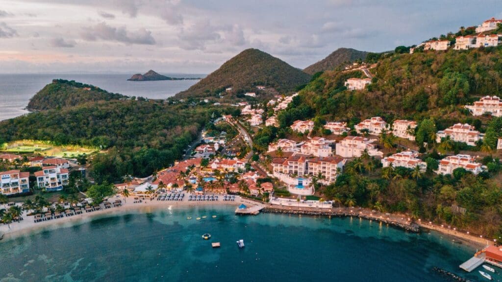 drone photo of Windjammer Landing in St. Lucia with hills and Pigeon Island in the background