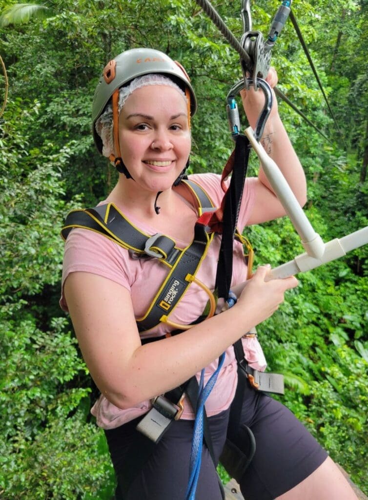 photo of woman sitting on zipline in St. Lucia