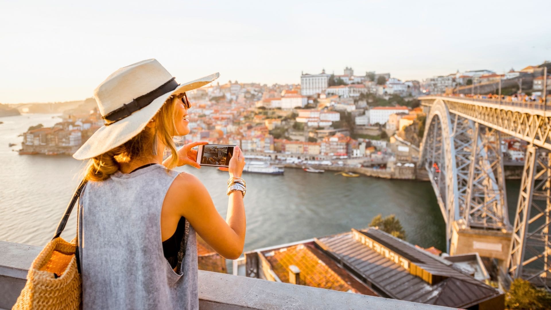 photo of woman taking photo and looking out in the distance