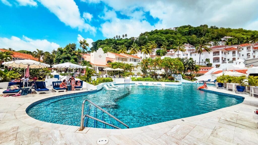 photo of pool and lounge area with villas in the background at Windjammer Landing in St. Lucia