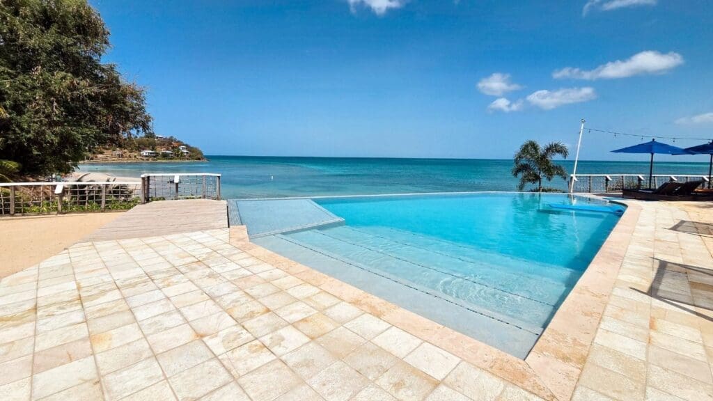 photo with the view of the beach and Caribbean Sea from Sunset Pool at Cocobay Resort