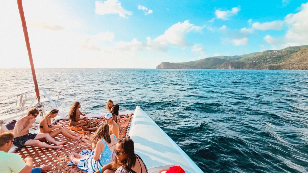 photo of people on catamaran sailing down the coast of St. Lucia