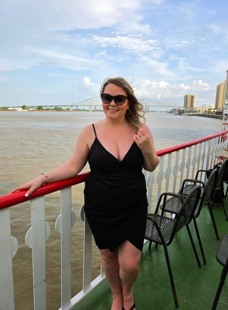 photo of woman standing on Steamboat in New Orleans