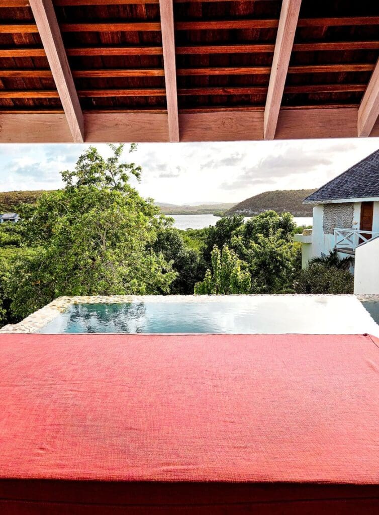 photo of daybed, trees, plunge pool. and bay from The Escape in Antigua