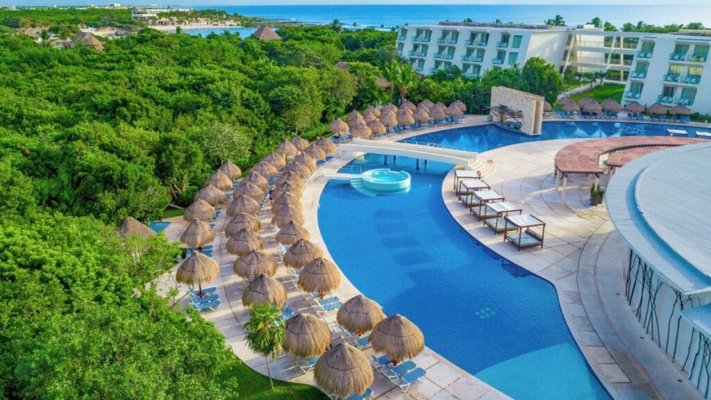 photo of lounge chairs, umbrellas and lazy river at Grand Sirenis Riviera Maya Resort & Spa